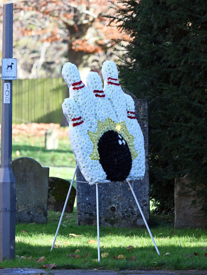 A bowling pin and ball flower arrangement at the funeral