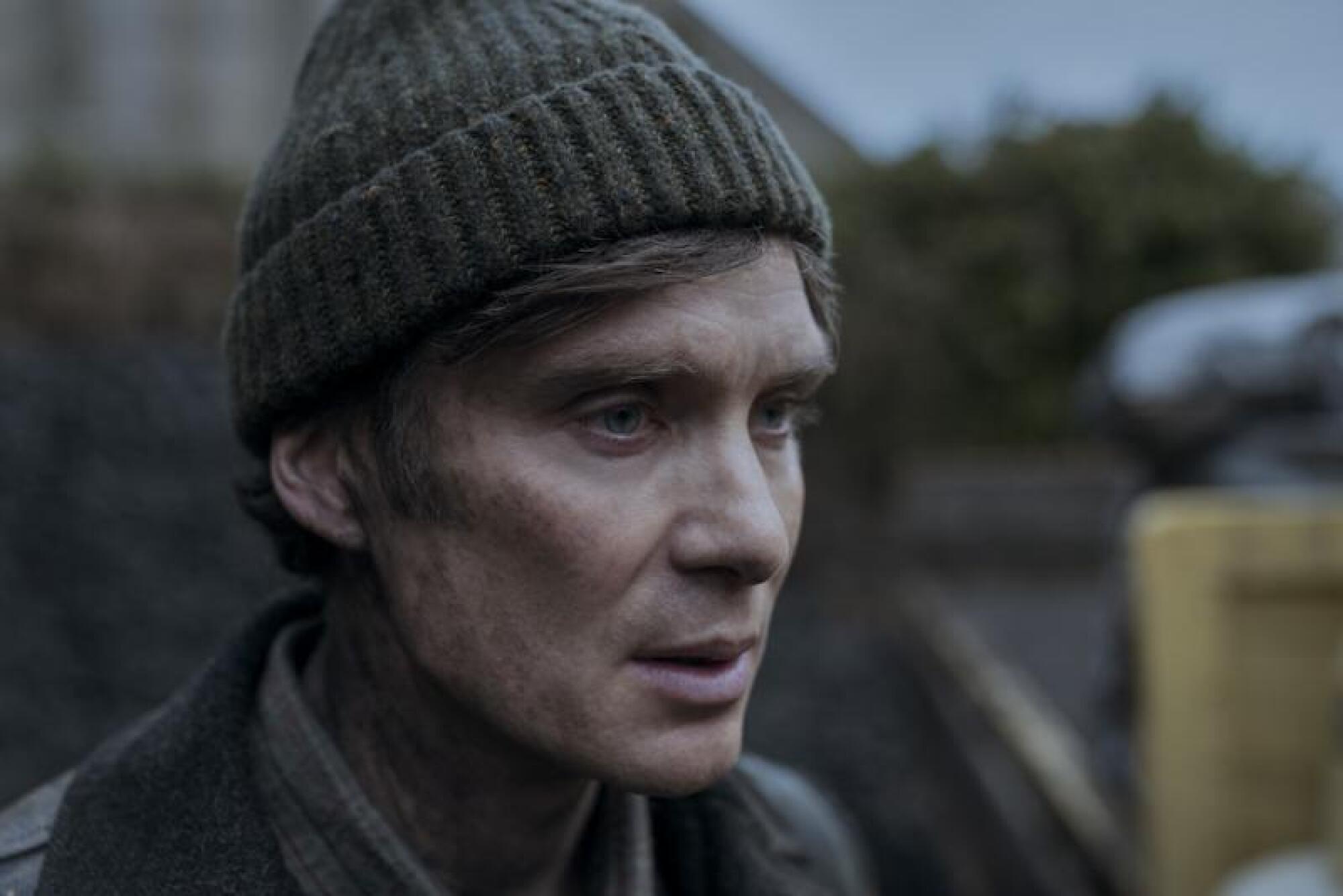 Cillian Murphy in a jacket and knit hat in "Small Things Like These."