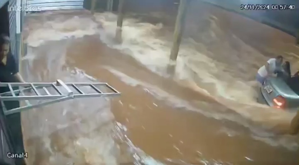 A ladder was trying to reach them, but it was too far away for them to let go of the car