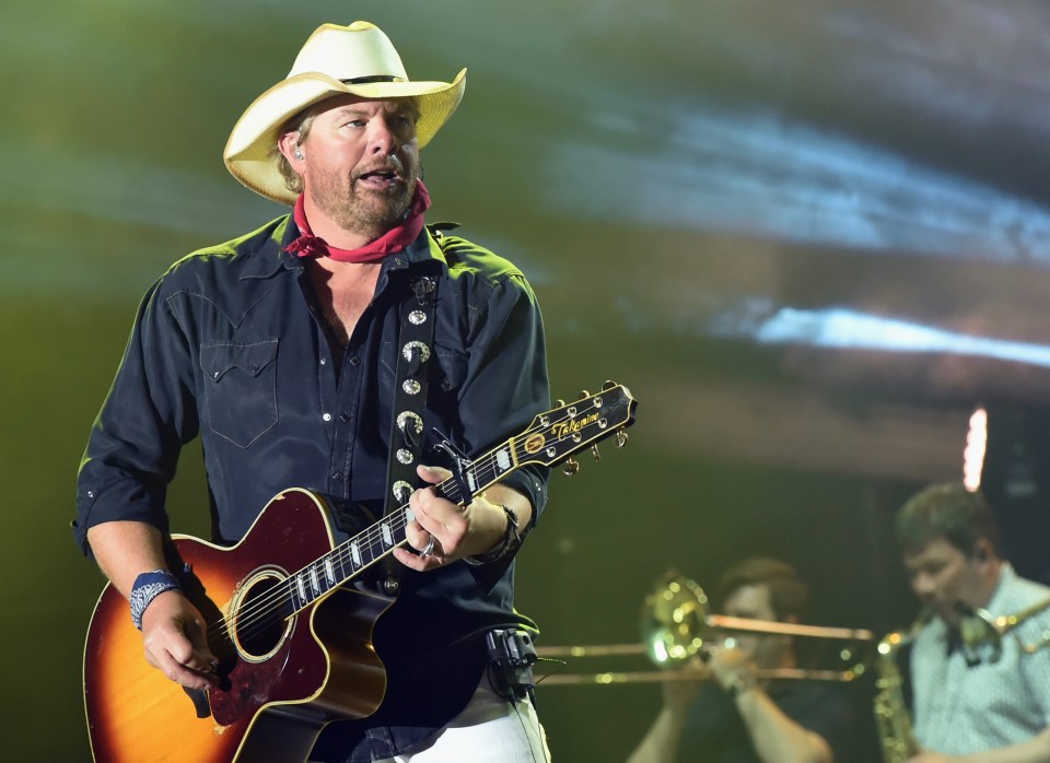 Toby Keith can be seen above performing on stage