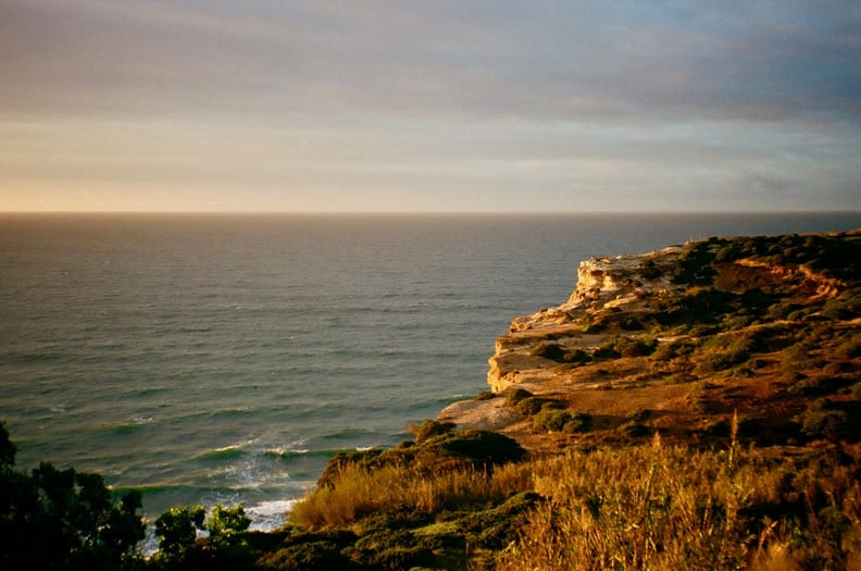 A photo shows a rocky coastline and blue ocean in Portugal.