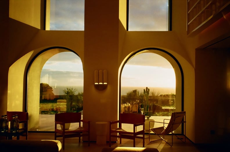 A photo shows two chairs in front of windows at Aethos Ericeira hotel in Portugal.