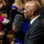 denzel washington holding a microphone