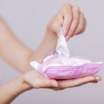 A woman uses makeup wipes