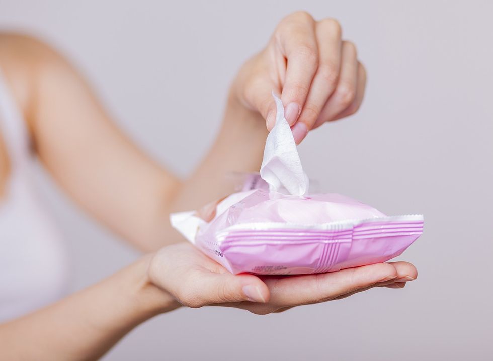 A woman uses makeup wipes