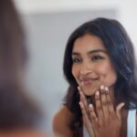 woman looking at herself in the mirror