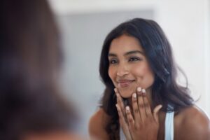 woman looking at herself in the mirror