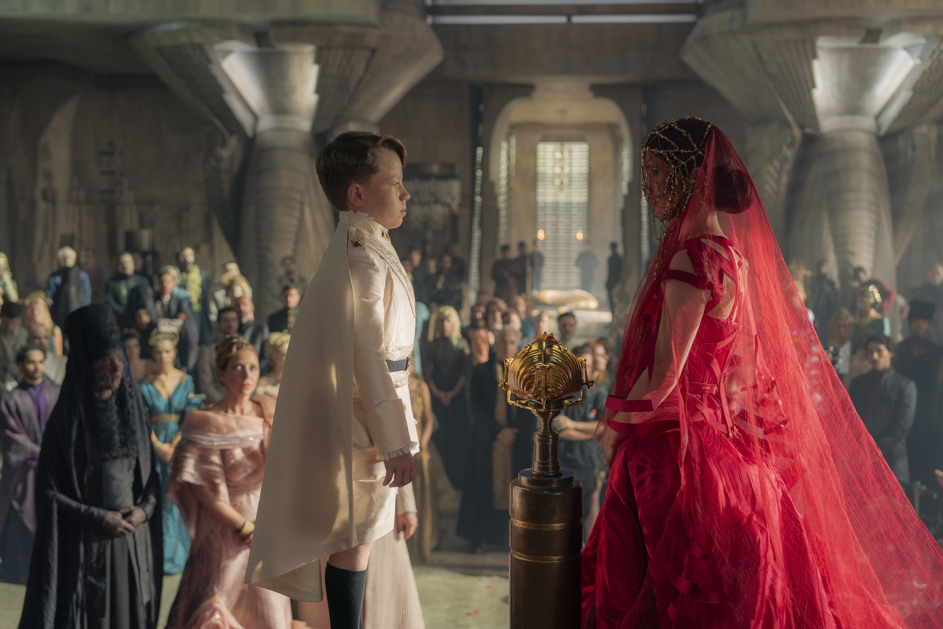 Princess Ynez (Sarah-Sofie Boussina) standing in front of her betrothed, a 9-year-old boy, at their engagement ceremony