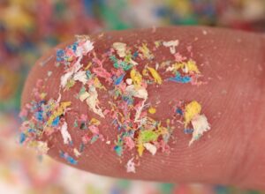 Close-up shot of microplastics on human finger