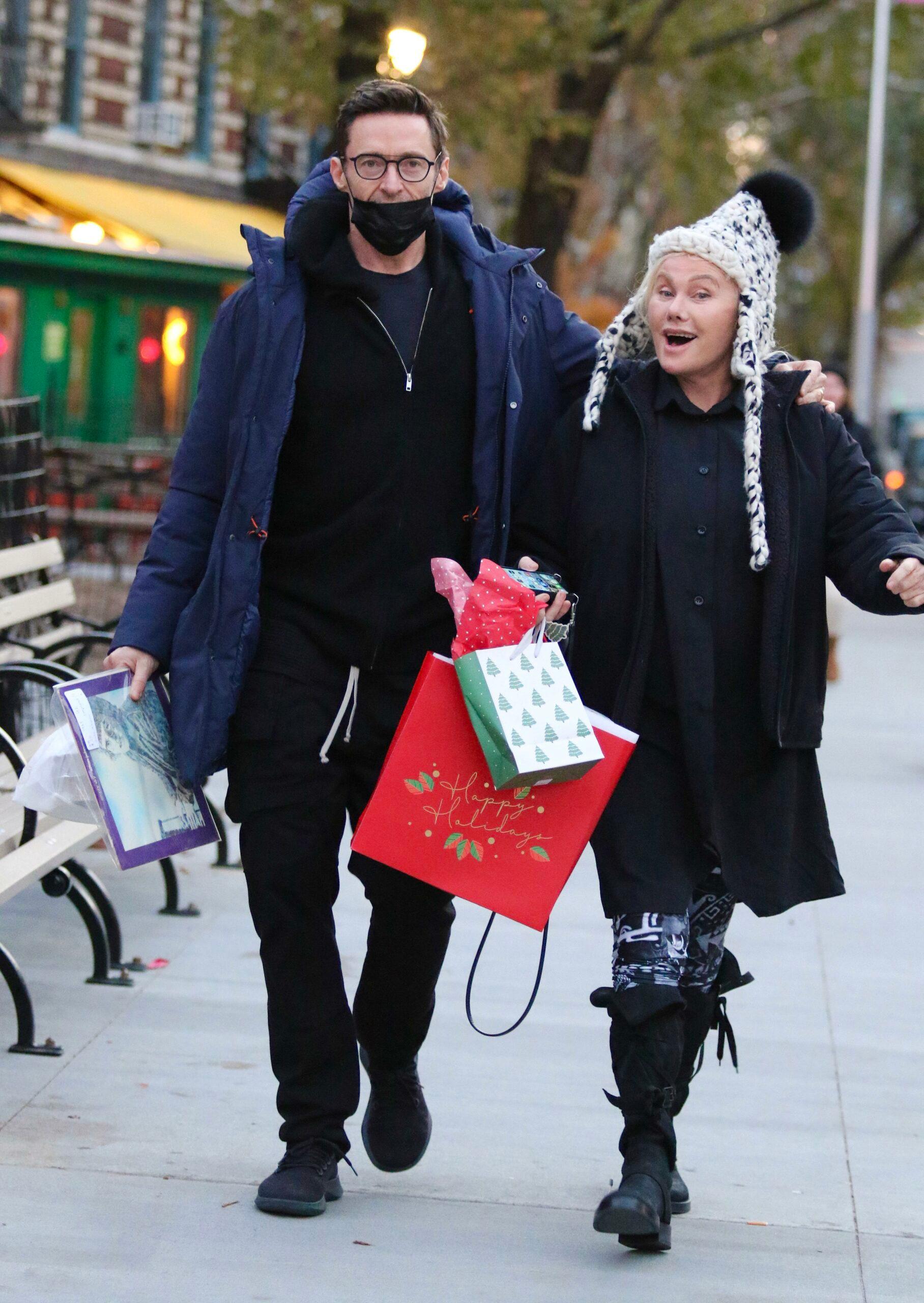 Hugh Jackman and wife Deborra-Lee Furness carry early Christmas presents and a copy of Elton Johns EMPTY SKY debut studio album after having a late lunch in NYC