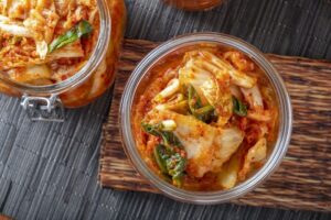 overhead view of kimchi in glass jars