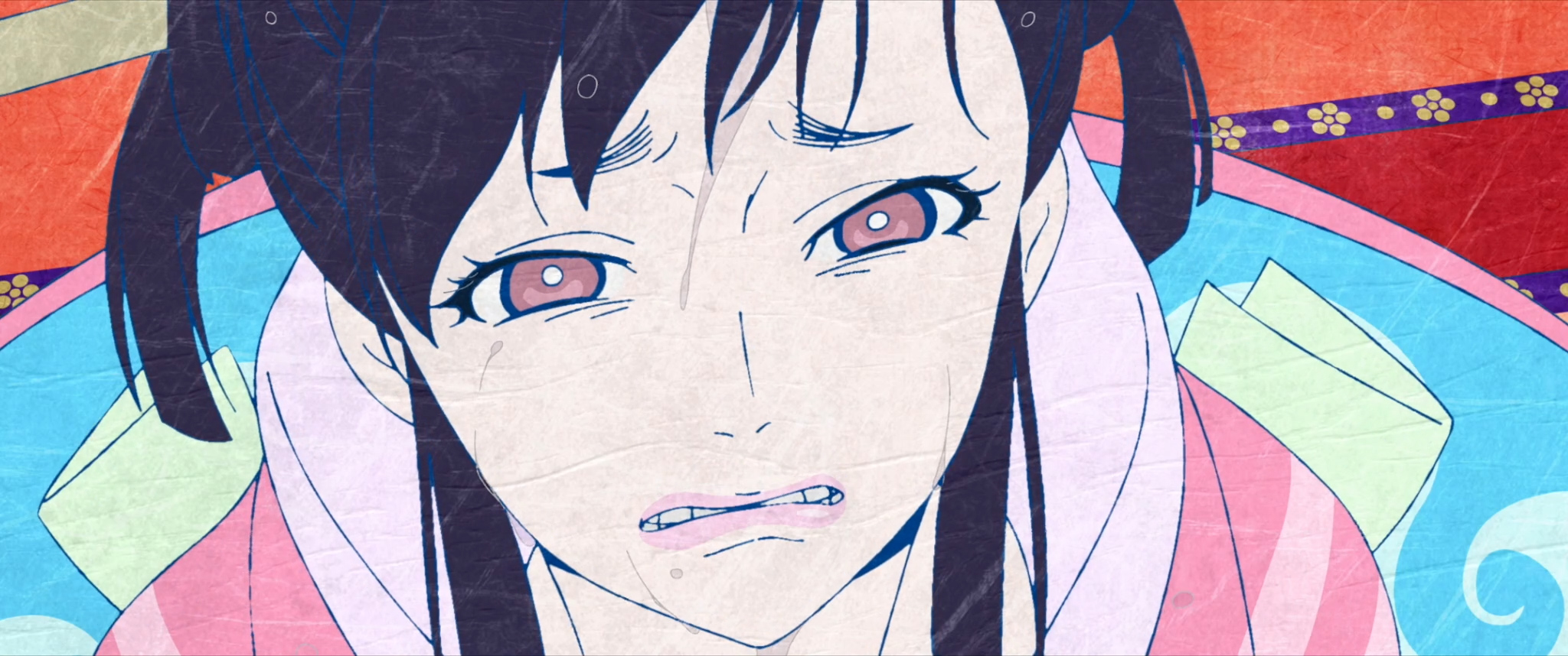 A dark-haired young woman in a pink kimono, face scrunched up as if she’s about to burst into tears, seen in extreme closeup in Mononoke the Movie: The Phantom in the Rain