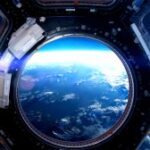 view of earth from porthole on international space station