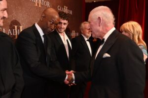 Denzel Washington meets King Charles III as Paul Mescal stands to his left as they attend the Royal Film Performance and Global Premiere of "Gladiator 2" on Nov. 13 in London.