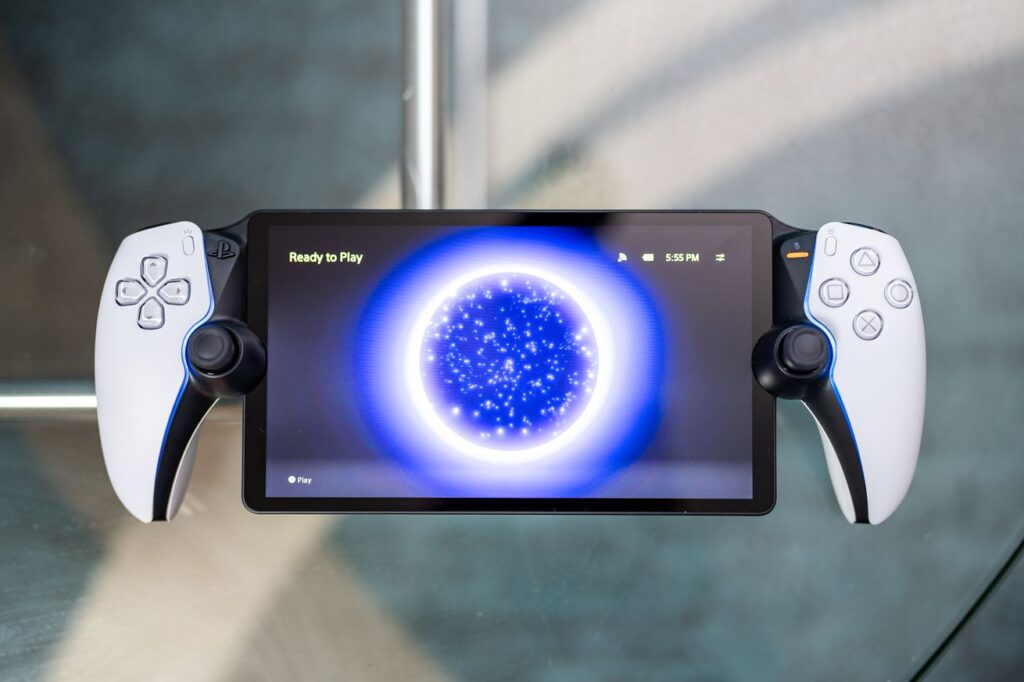 The PlayStation Portal resting on a glass coffee table.