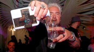 Guy Fieri pouring Santo tequila