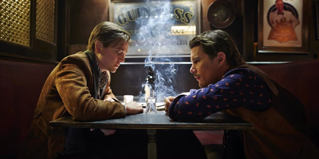 Sarah Snook and Ethan Hawke sitting across from one another in a bar in Predestination.