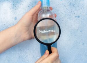 A bottle containing phthalates under a magnifying glass