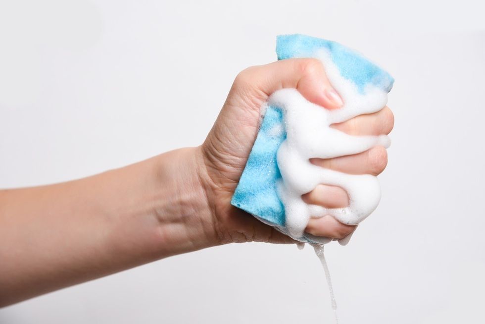 A wet sponge being squeezed