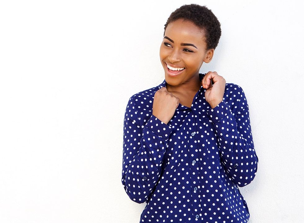 A stylish woman wearing a polka dot shirt