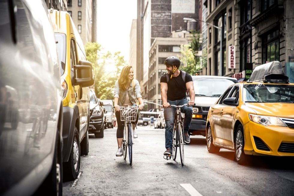 A couple riding bikes in the city