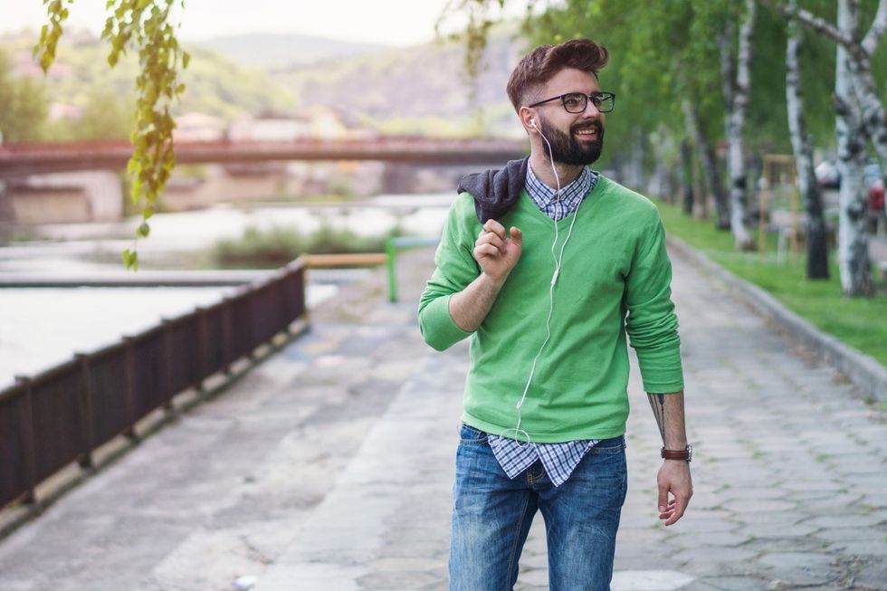 young white man walking outside along river