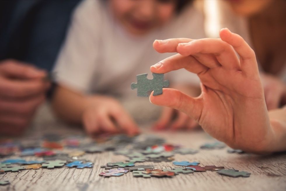 Friends do a jigsaw puzzle together