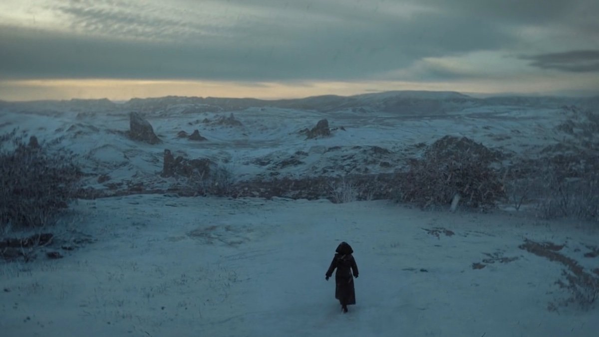 A woman walks in the snow of a desolate planet on Dune: Prophecy