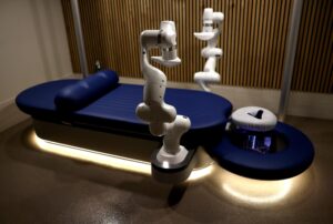 An empty massage table with robotic arms.