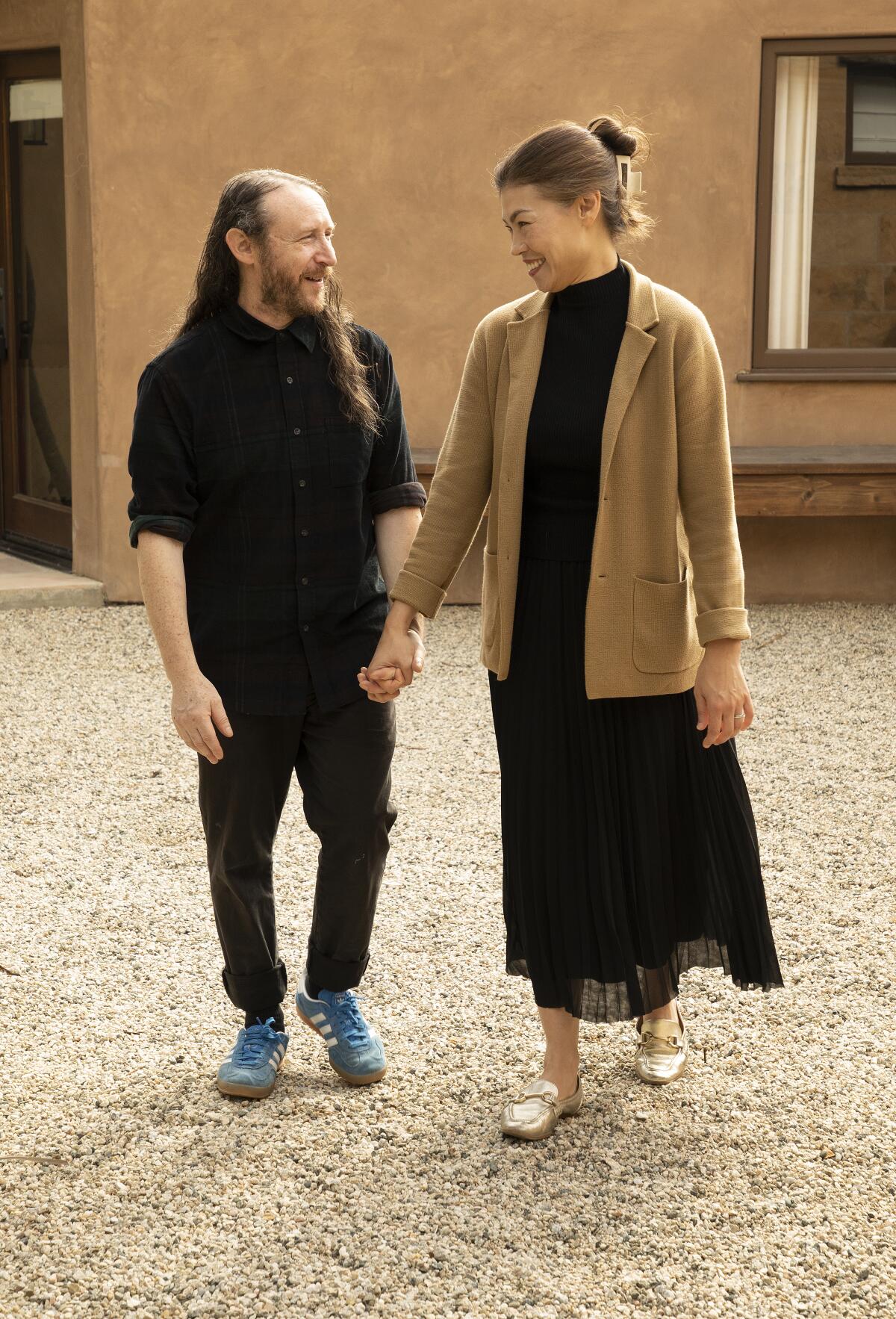 A couple walking and holding hands