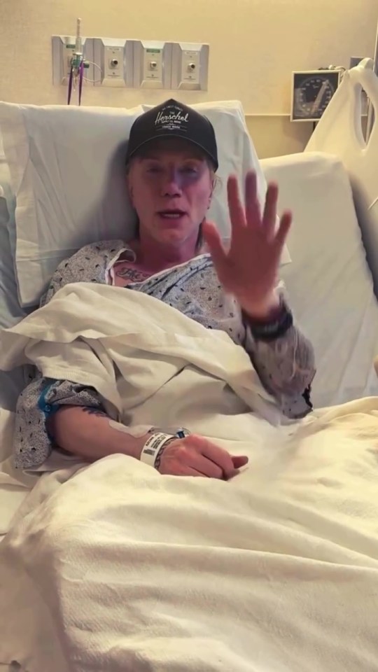 John Rzeznik could be seen laying in the hospital bed with a cap on