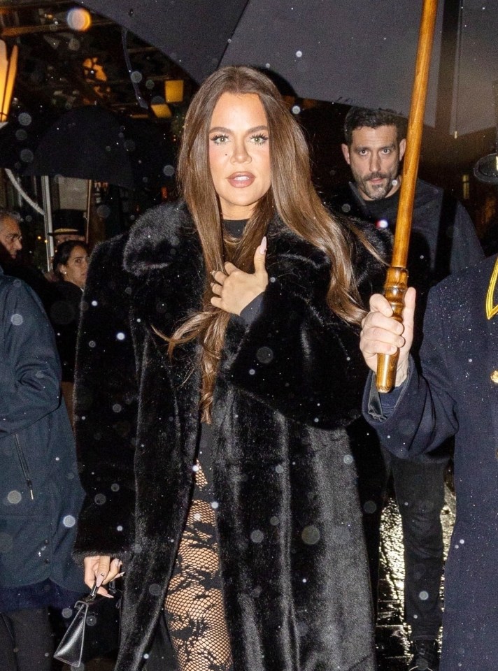 Khloe wore a black long fur coat