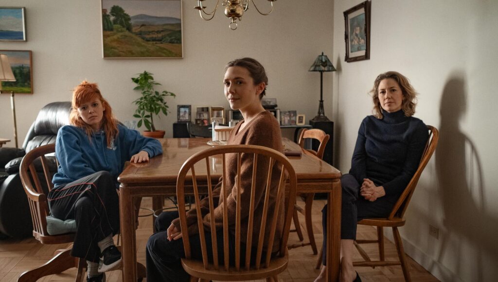 Three women sit at a dining table in 'His Three Daughters.'