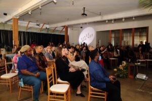 People sit in chairs at Level Ground Co.'s Re-Union: 10 Year Anniversary Soirée in downtown L.A.