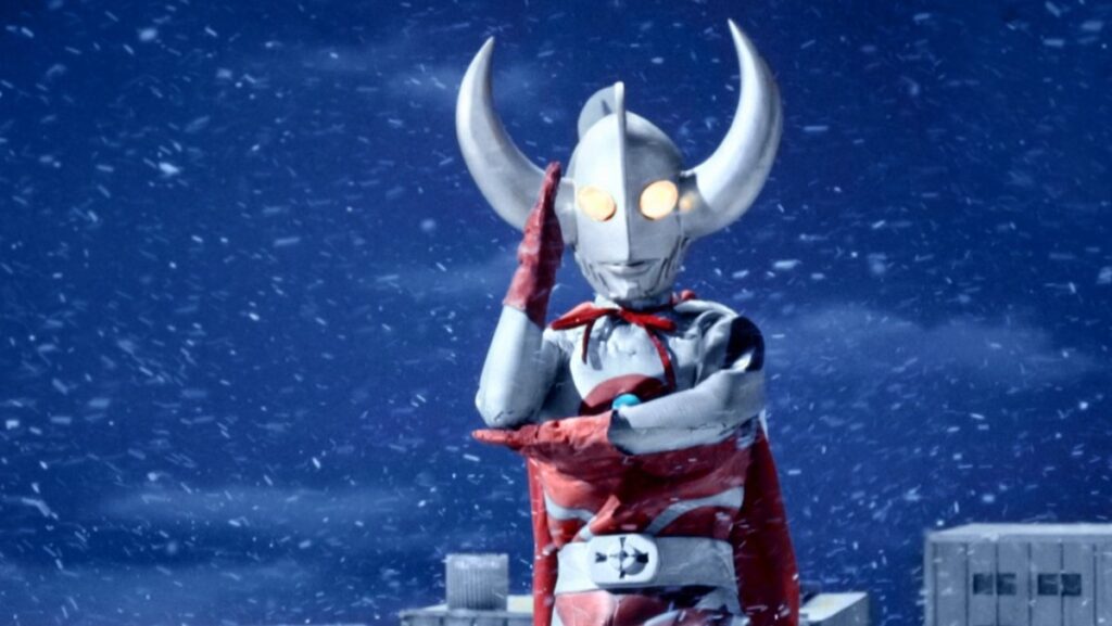 Father of Ultra wearing a red cape amid a snow storm in Ultraman Ace.