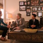 An older woman shakes hands with a younger woman as two others join her on the couch in a scene from "Matlock."