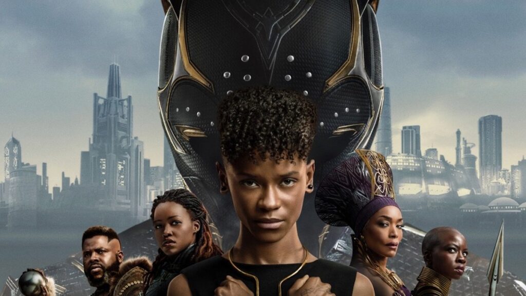 Part of an official poster for Black Panther: Wakanda Forever with all of the major characters from Wakanda lined up and Shuri in the cenetr in front of a Black Panther mask