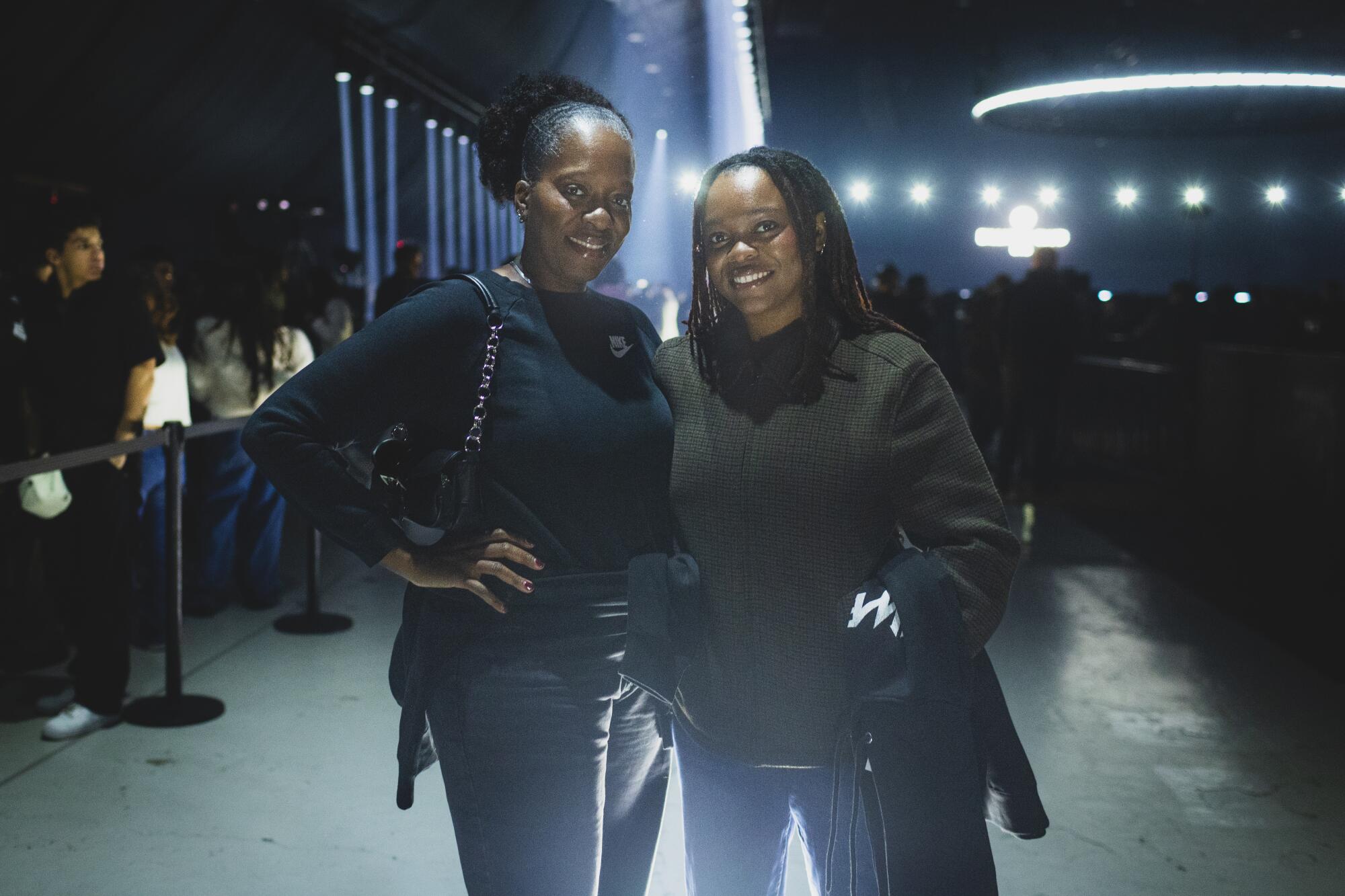 Kenyah Moore and Shenita Moore pose outdoors at night.