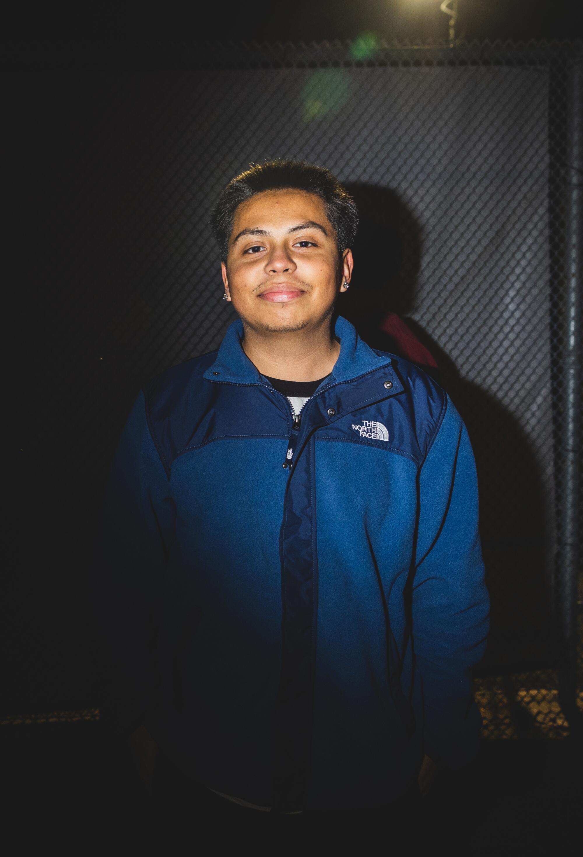 David Reyes, 19, of Riverside poses in the dark outdoors.