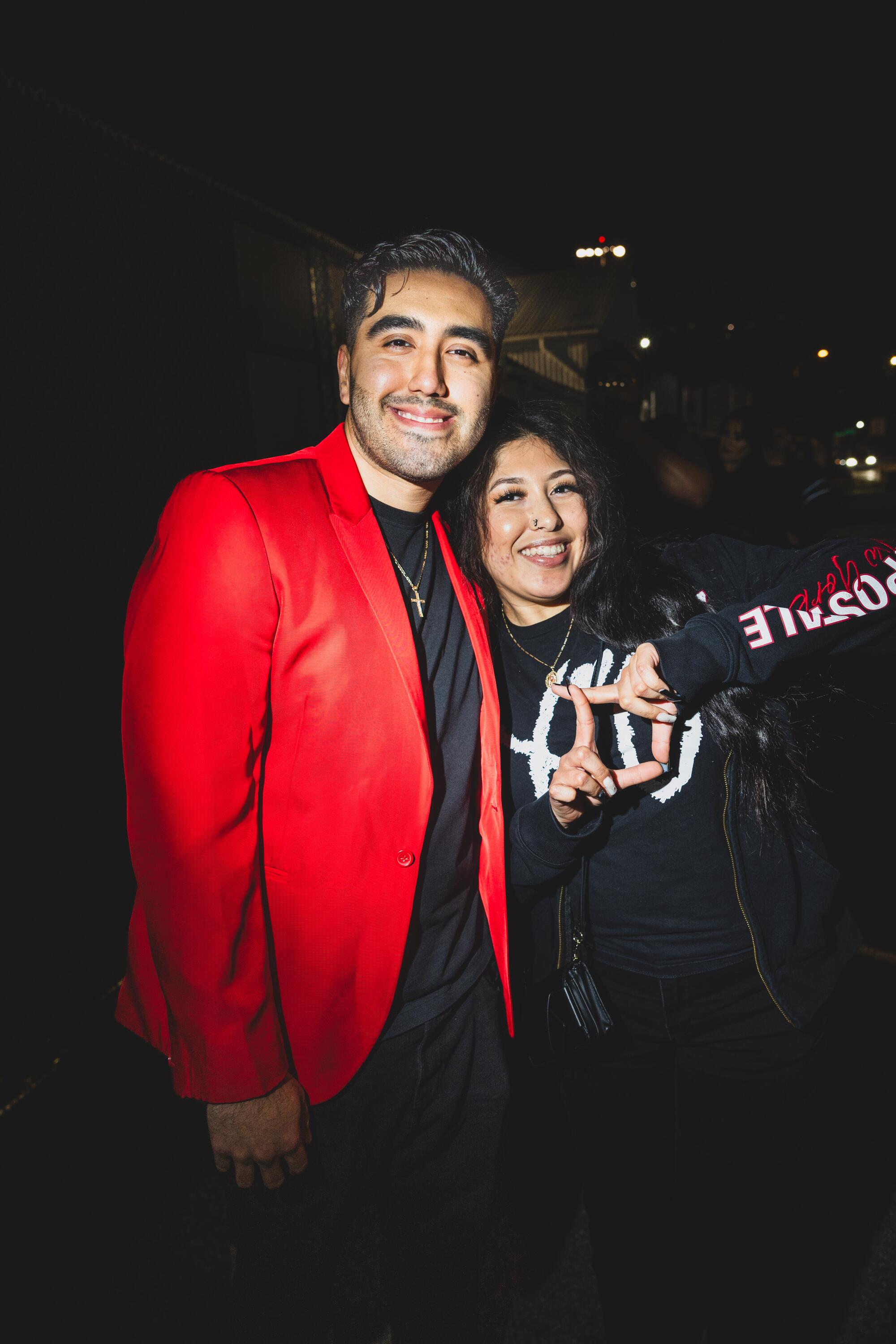 Catherine Carrasco, 25, and Jonathan Serna, 26, pose outdoors at night.