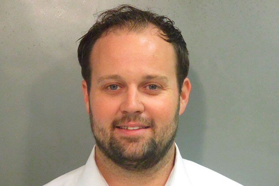 Josh smiled in his mugshot after his 2021 arrest on child pornography charges