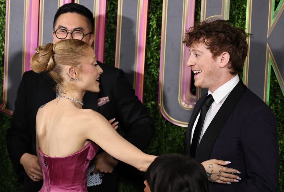 Ariana Grande and Ethan Slater embracing at the Wicked New York Premiere on November 14