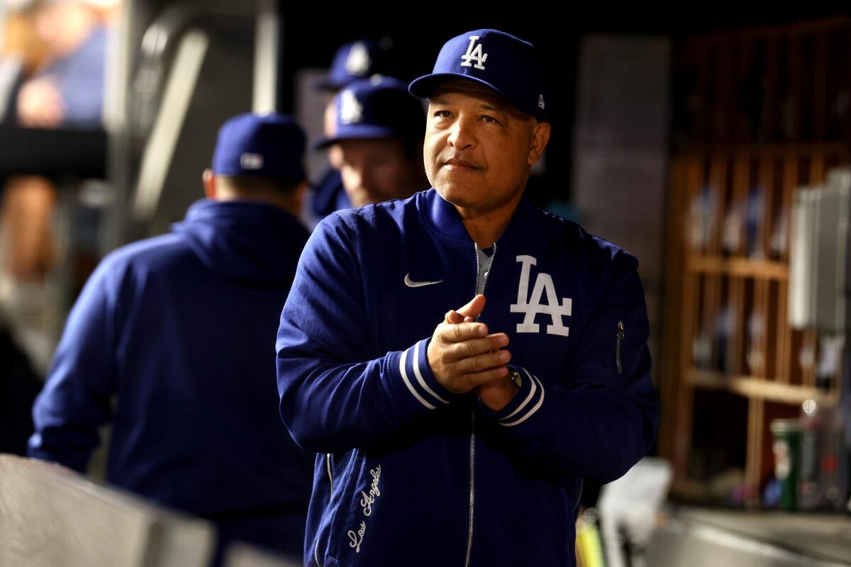 Dave Roberts walks in the dugout before Game 5 of the World Series against the New York Yankees on Oct. 30.