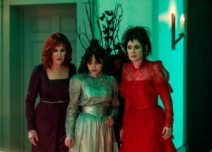 Three women of varying ages look startled in "Beetlejuice Beetlejuice."