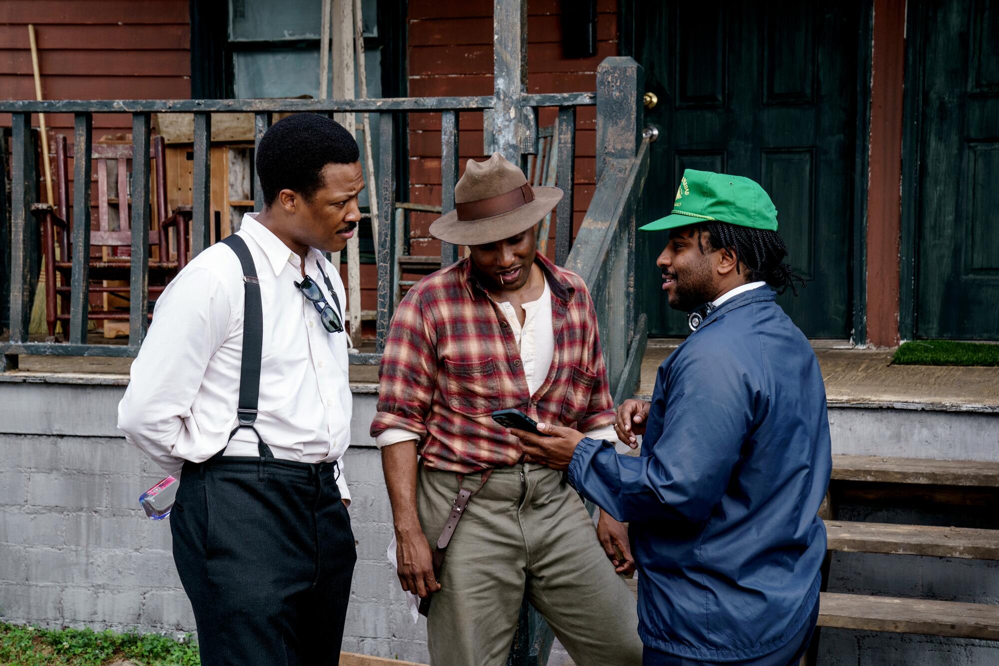  Three men talk on the set of "The Piano Lesson."