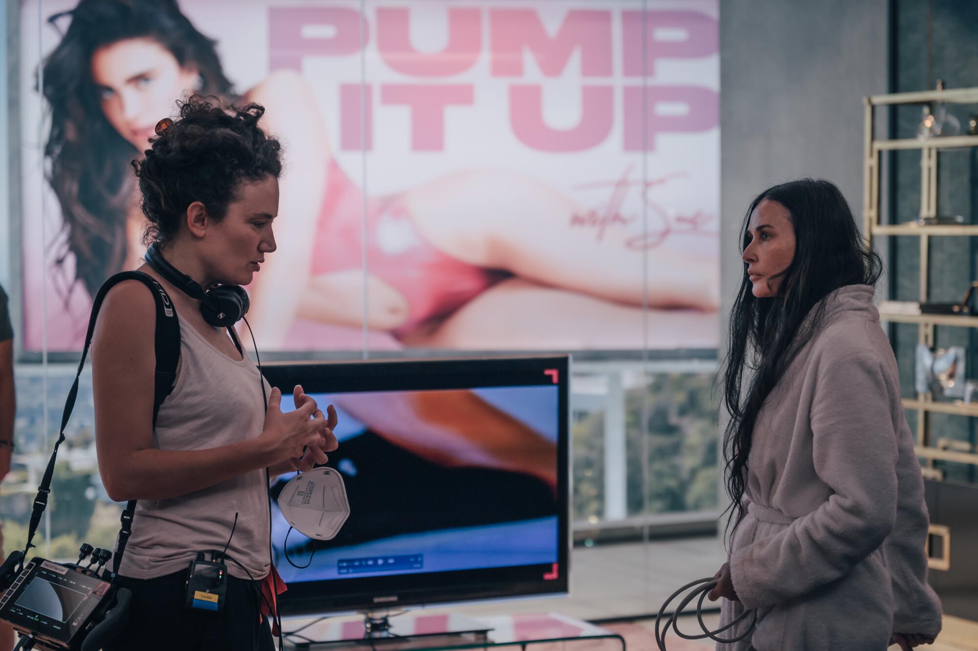 Two women talk on a film set.