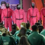 Costumed "Squid Game" guards watch over the crowd at the premiere of the second season of the Netflix series.