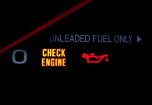 A check engine and check oil light on a dashboard