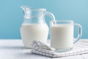 A jug of milk on blue background