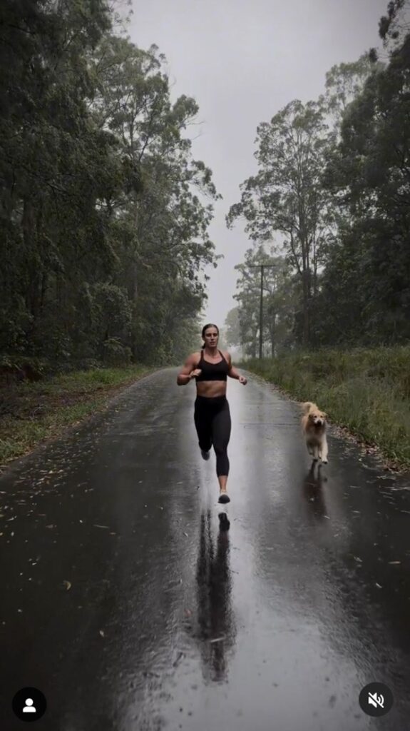 Harriet Roberts is seen running in the rain with her dog.